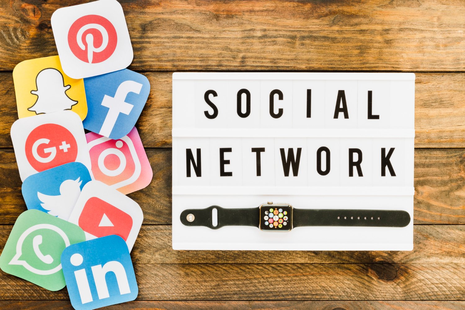 smartwatch displaying social media networking icons on wooden table digital marketing concept
